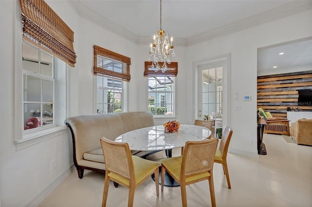 dining room with ornamental molding and an inviting chandelier