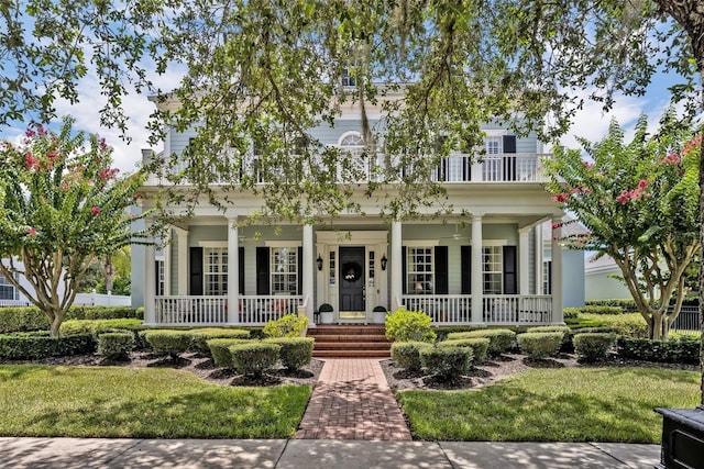 view of front of house featuring covered porch and a front lawn