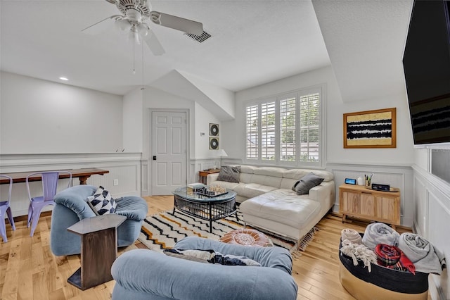 living room with light hardwood / wood-style flooring and ceiling fan