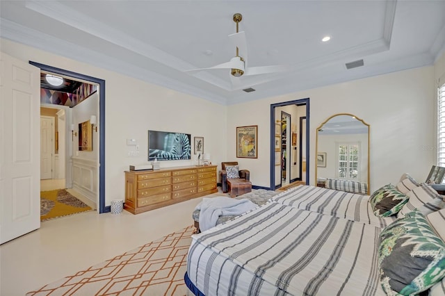 bedroom featuring ceiling fan, ornamental molding, connected bathroom, and a raised ceiling