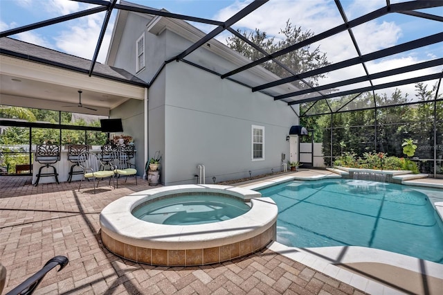 view of swimming pool with an in ground hot tub, an outdoor bar, ceiling fan, glass enclosure, and a patio area