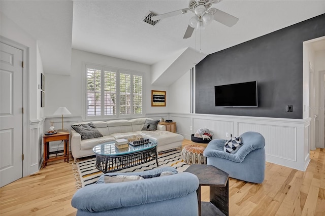 living room featuring ceiling fan and light wood-type flooring