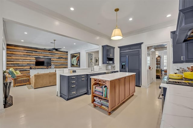 kitchen featuring pendant lighting, light stone countertops, kitchen peninsula, and wood walls