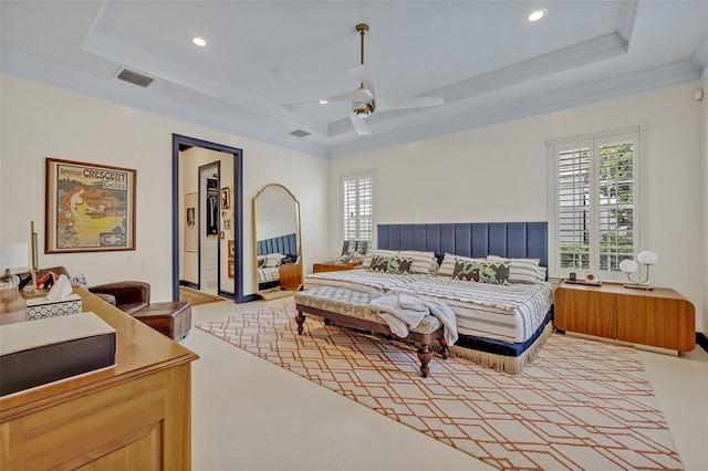 bedroom with crown molding, ceiling fan, and a tray ceiling