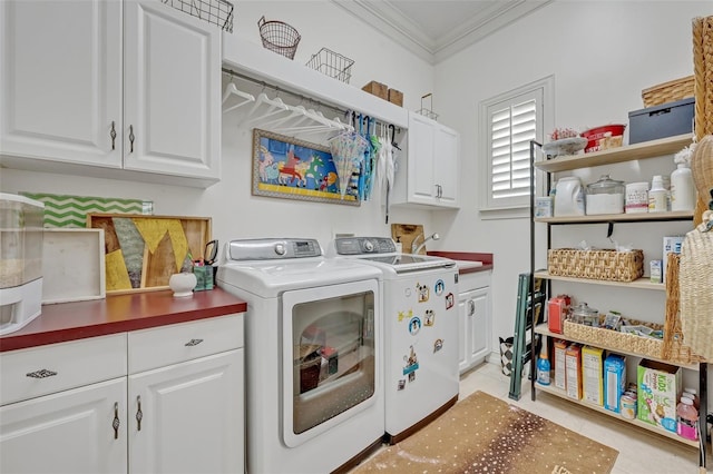 laundry room featuring cabinets, crown molding, light tile patterned floors, and washer and clothes dryer