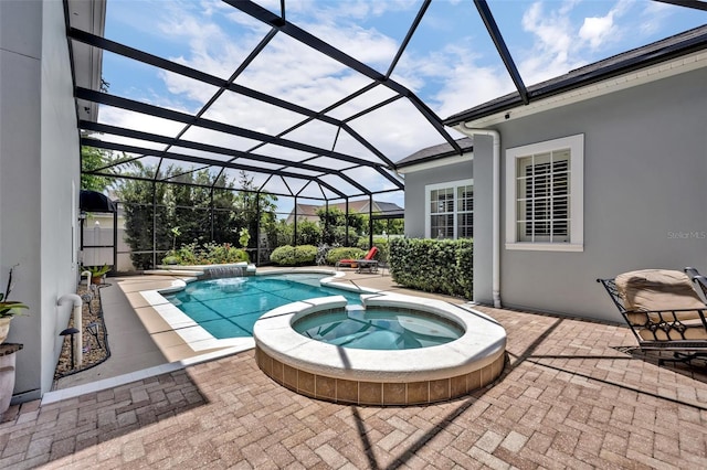 view of pool featuring a patio, glass enclosure, and an in ground hot tub