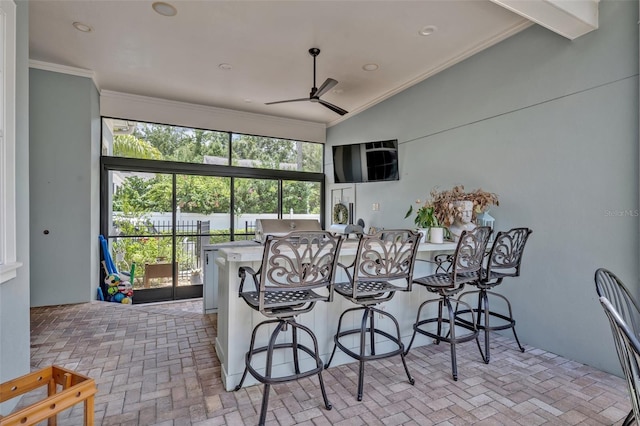 interior space featuring crown molding, lofted ceiling, and ceiling fan