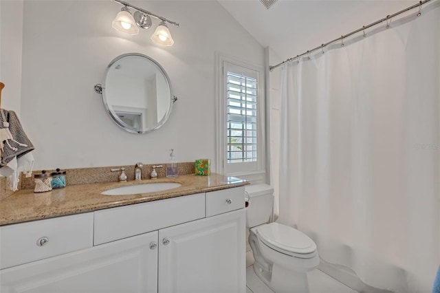 bathroom with a shower with curtain, vaulted ceiling, vanity, and toilet