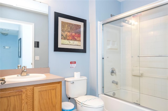 full bathroom with vanity, toilet, and enclosed tub / shower combo