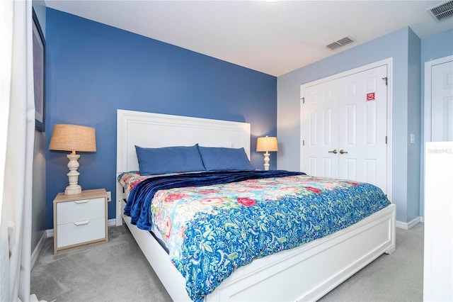 bedroom featuring a closet and light colored carpet