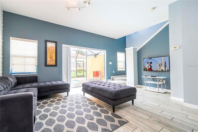 bedroom featuring access to outside, hardwood / wood-style flooring, and rail lighting