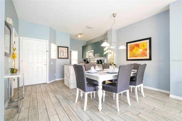 dining space with light wood-type flooring