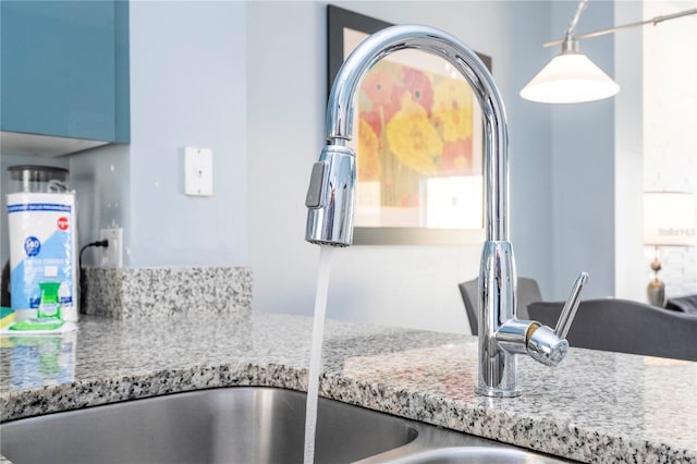 interior details featuring sink and decorative light fixtures