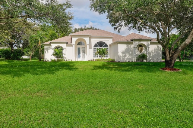 mediterranean / spanish house with a front lawn