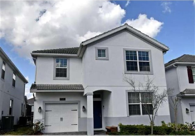 1585 Mulligan Blvd, Davenport, FL 33896 - view of front of house featuring an attached garage, stucco siding, and a tiled roof