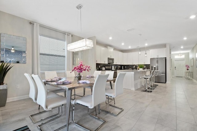 dining space featuring light tile patterned floors and ceiling fan