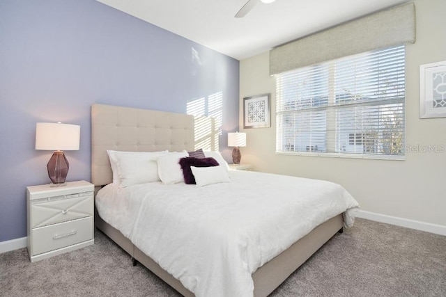 bedroom featuring light carpet and ceiling fan