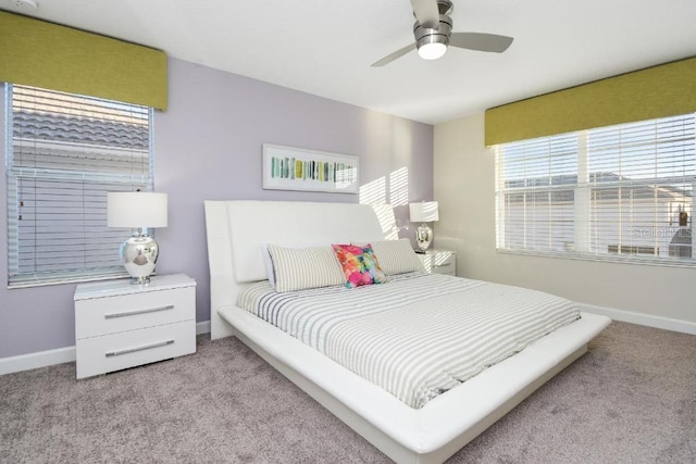 bedroom with light carpet and ceiling fan