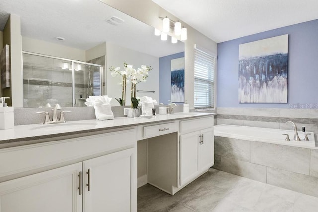 bathroom with dual bowl vanity, tile patterned floors, and separate shower and tub