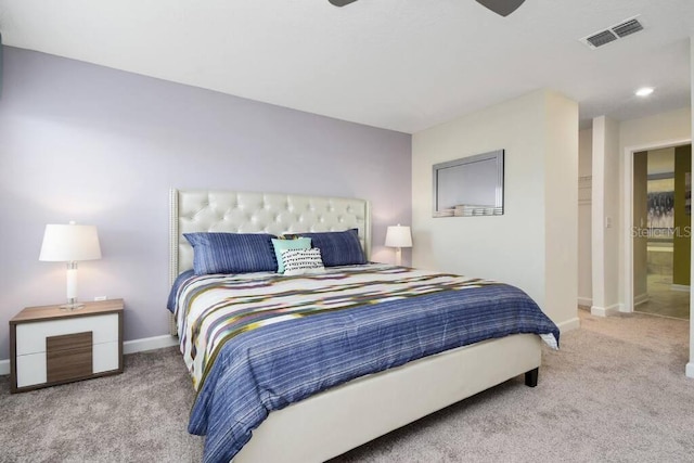 carpeted bedroom featuring ensuite bathroom and ceiling fan