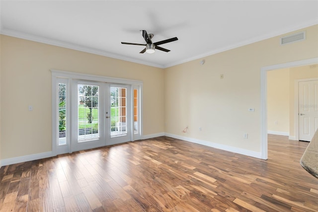 unfurnished room with ceiling fan, french doors, crown molding, and hardwood / wood-style floors