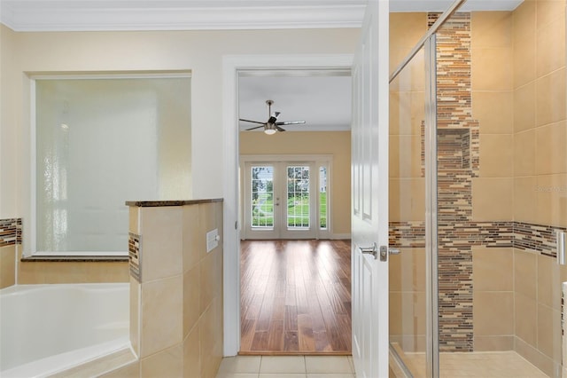 bathroom featuring tile patterned floors, crown molding, french doors, and shower with separate bathtub