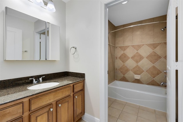 bathroom with vanity, tiled shower / bath, and tile patterned flooring