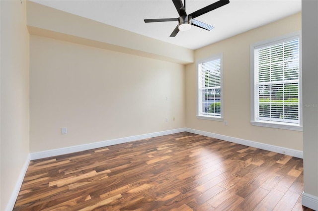 empty room with ceiling fan and dark wood-type flooring