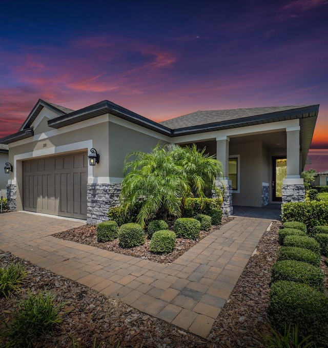 view of front of house featuring a porch and a garage