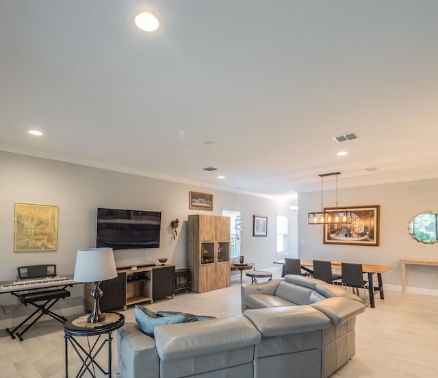 living room featuring crown molding and light hardwood / wood-style floors