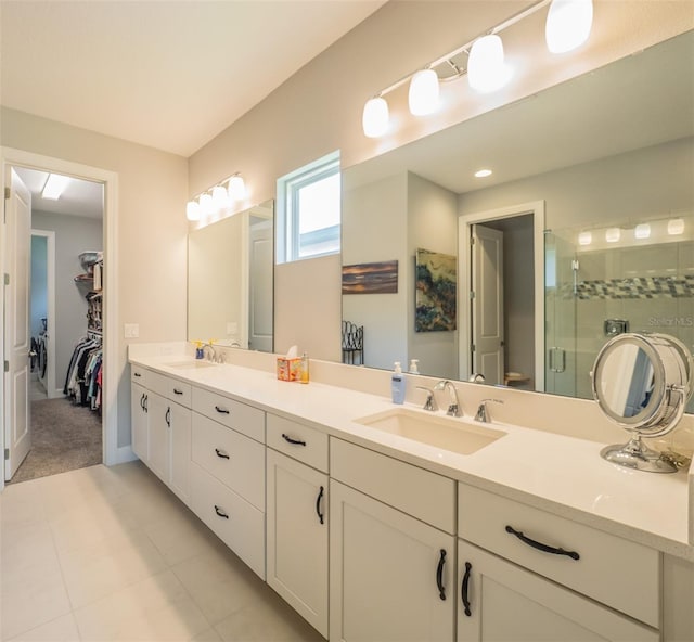 bathroom with tile patterned floors, vanity, and an enclosed shower