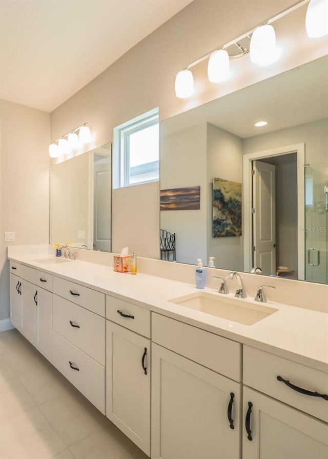 bathroom with vanity, tile patterned flooring, and a shower with door