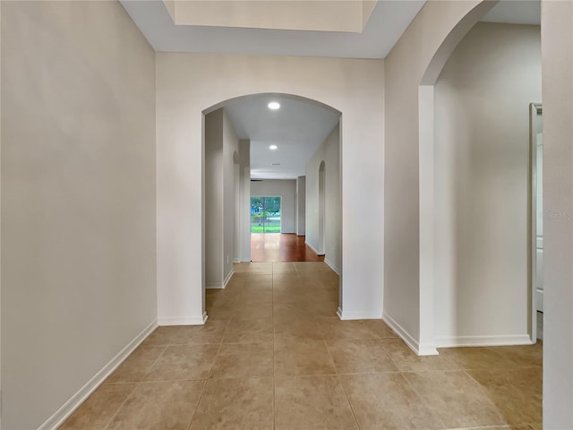 hall with light tile patterned floors