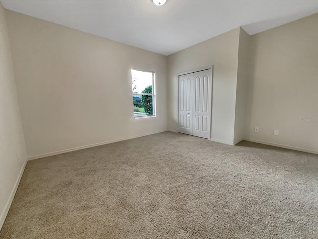 unfurnished bedroom featuring carpet floors and a closet