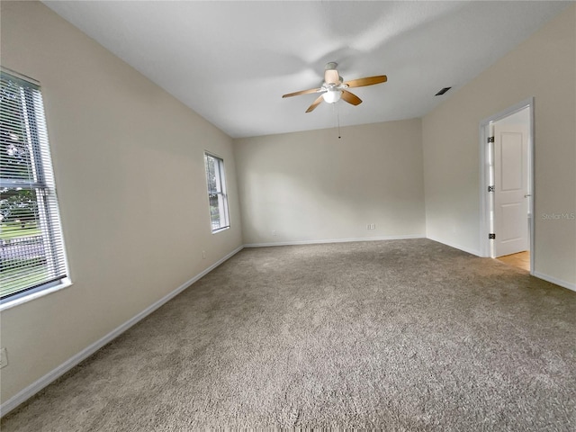 carpeted empty room featuring ceiling fan