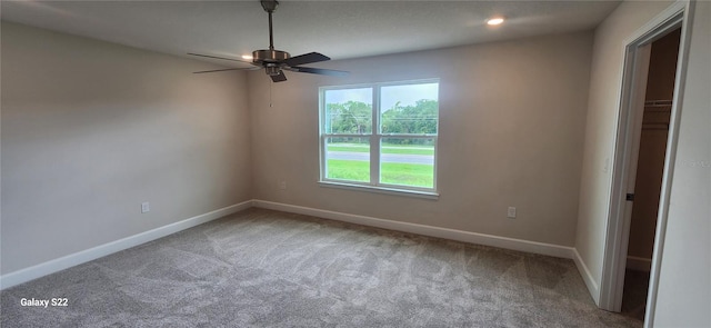 spare room featuring ceiling fan and carpet flooring