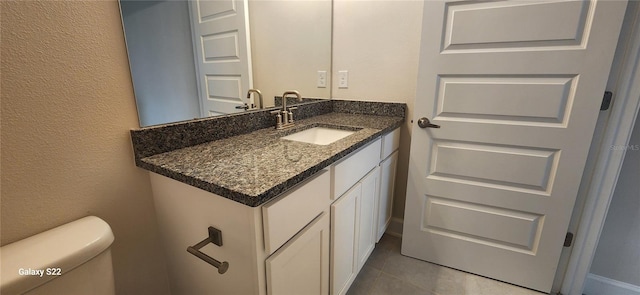 bathroom with vanity, tile patterned floors, and toilet