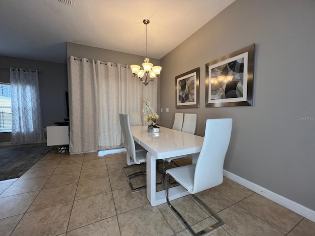 tiled dining area featuring a notable chandelier