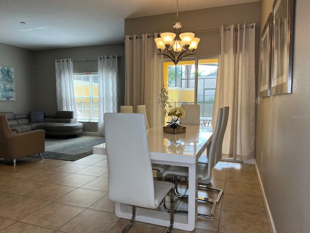 tiled dining area with an inviting chandelier and a wealth of natural light