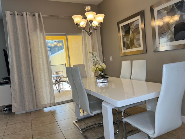 dining room featuring a notable chandelier and light tile patterned flooring