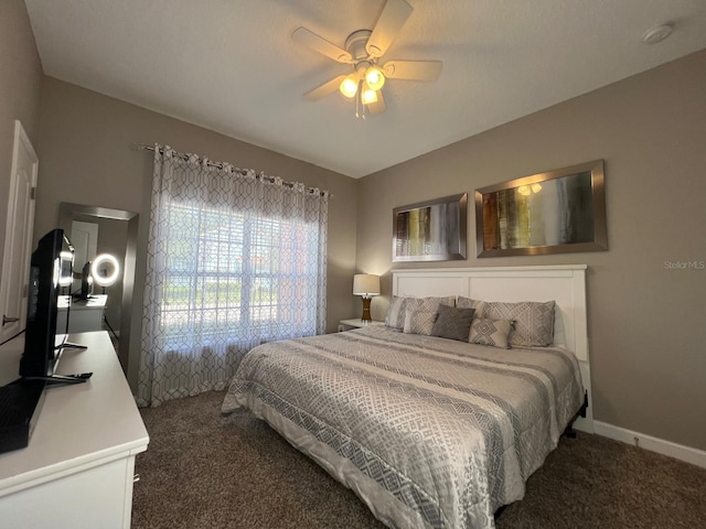 bedroom with dark carpet and ceiling fan