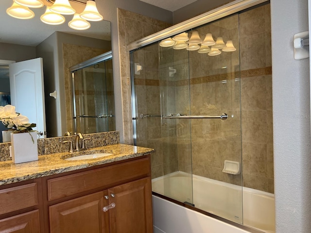 bathroom with vanity and bath / shower combo with glass door