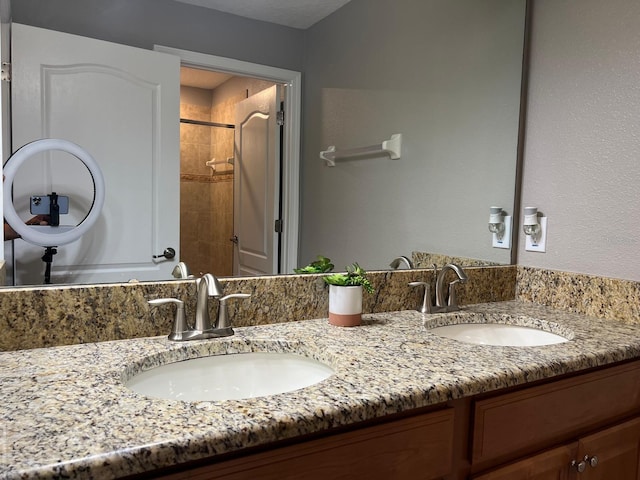 bathroom featuring vanity and tiled shower