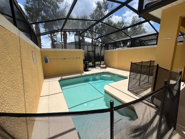 view of swimming pool featuring a patio area and glass enclosure