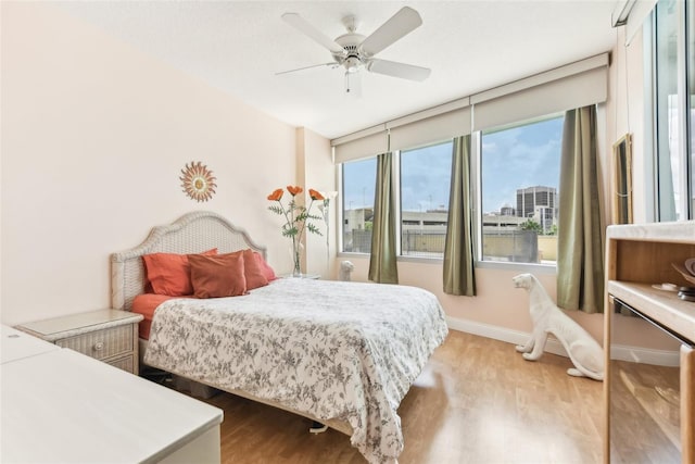 bedroom with ceiling fan and light hardwood / wood-style flooring