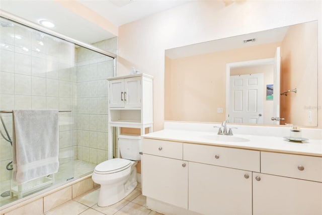 bathroom with vanity, a shower with shower door, toilet, and tile patterned floors