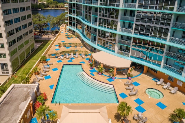 view of pool featuring a patio and a water view