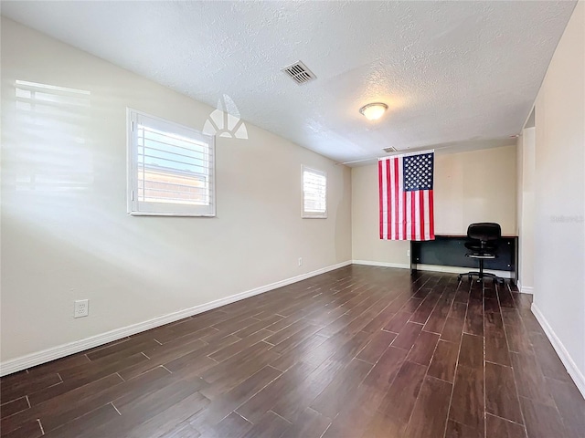 unfurnished office with a textured ceiling