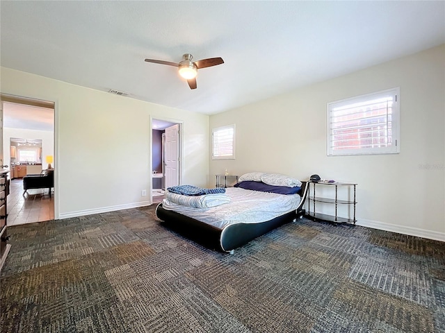 bedroom featuring ceiling fan and dark carpet