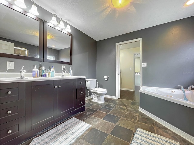 bathroom featuring a tub, a textured ceiling, toilet, and vanity